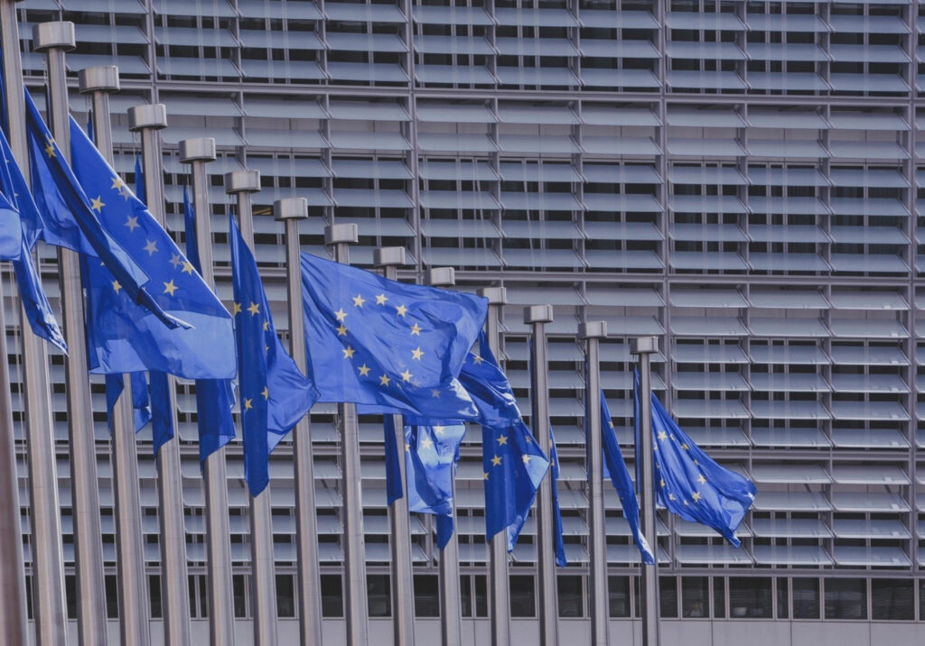 EU flags outside the European Commission, where the EU AI Act for SMEs was drafted